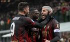 AC Milan's Theo Hernandez, right, celebrates with his teammates after he scored his side's first goal during a Serie A soccer match between AC Milan and Atalanta, at Milan's San Siro Stadium, Sunday, Feb. 26, 2023. (AP Photo/Antonio Calanni)