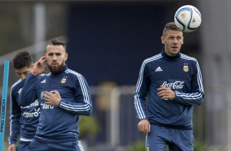 Argentina's Martin Demichelis, right, and Nicolas Otamendi attend a training session in Buenos Aires, Argentina, Monday, Oct. 5, 2015. Argentina will face Ecuador for a 2018 World Cup Russia qualifier soccer match in Buenos Aires on October 8. (AP Photo/Natacha Pisarenko)