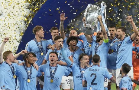 Manchester City players celebrate with the trophy after winning the Champions League final soccer match between Manchester City and Inter Milan at the Ataturk Olympic Stadium in Istanbul, Turkey, Sunday, June 11, 2023. Manchester City won 1-0. (AP Photo/Francisco Seco)