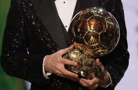 PSG player Lionel Messi holds the 2021 Ballon d'Or trophy during the 65th Ballon d'Or ceremony at Theatre du Chatelet, in Paris, Monday, Nov. 29, 2021. Messi won the Ballon d'Or for seventh time. (AP Photo/Christophe Ena)