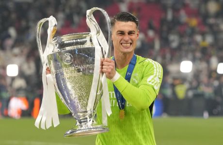 Real Madrid's goalkeeper Kepa Arrizabalaga celebrates with the trophy after winning the Champions League final soccer match between Borussia Dortmund and Real Madrid at Wembley stadium in London, Saturday, June 1, 2024. (AP Photo/Kirsty Wigglesworth)