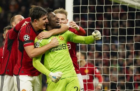 Manchester United's goalkeeper Andre Onana, right, celebrates with teammates after makes a save penalty shoot during the Champions League group A soccer match between Manchester United and Copenhagen at the Old Trafford stadium in Manchester, England, Tuesday, Oct. 24, 2023. (AP Photo/Dave Thompson)