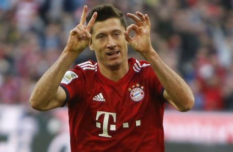 Bayern's Robert Lewandowski celebrates after scoring his side's second goal during the German Bundesliga soccer match between FC Bayern Munich and Borussia Dortmund in the Allianz Arena in Munich, Germany, on Saturday, April 6, 2019. (AP Photo/Michael Probst)