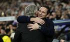 Chelsea's caretaker coach Frank Lampard, right, greets Real Madrid's head coach Carlo Ancelotti prior the Champions League quarter final first leg soccer match between Real Madrid and Chelsea at Santiago Bernabeu stadium in Madrid, Wednesday, April 12, 2023. (AP Photo/Jose Breton)