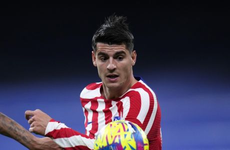 Atletico Madrid's Alvaro Morata goes for the ball past Real Madrid's Eder Militao during a Spanish La Liga soccer match between Real Madrid and Atletico Madrid at the Santiago Bernabeu stadium in Madrid, Spain, Saturday, Feb. 25, 2023. (AP Photo/Manu Fernandez)