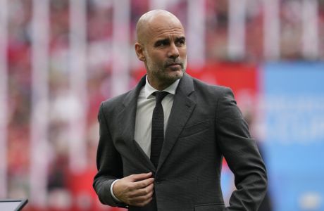 Manchester City's head coach Pep Guardiola gestures prior to the English FA Cup final soccer match between Manchester City and Manchester United at Wembley Stadium in London, Saturday, May 25, 2024. (AP Photo/Kin Cheung)