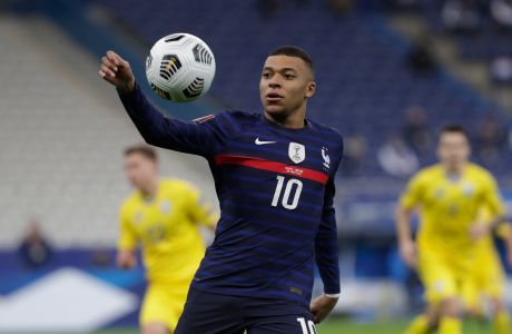 FILE - In this Wednesday, March 24, 2021 file photo, France's Kylian Mbappe controls the ball during the World Cup 2022 group D qualifying soccer match between France and Ukraine at the Start de de France stadium, in Saint Denis, north of Paris. With a chance to become the all-time top scorer with a national team, Cristiano Ronaldo will highlight the list of top players at this year's European Championship. Others who could make an impact include Kylian Mbappé, Robert Lewandowski, Kevin De Bruyne and Harry Kane. (AP Photo/Thibault Camus, File)