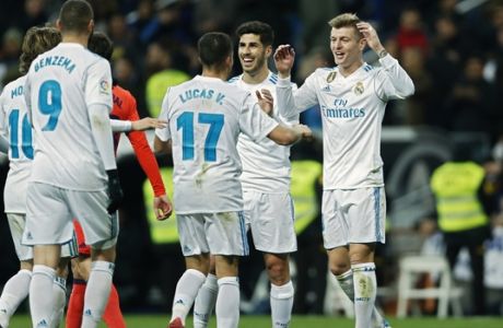 Real Madrid's Toni Kroos, right, celebrates with teammates after scoring a goal against Real Sociedad during a Spanish La Liga soccer match between Real Madrid and Real Sociedad at the Santiago Bernabeu stadium in Madrid, Saturday, Feb. 10, 2018. Kroos scored once in Real Madrid's 5-2 victory. (AP Photo/Francisco Seco)