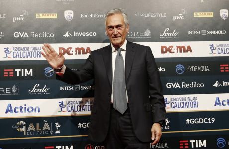 FIGC President Gabriele Gravina poses for photographer as he arrives for the Gran Gala' soccer awards ceremony, in Milan, Italy, Monday, Dec. 2, 2019. (AP Photo/Antonio Calanni)